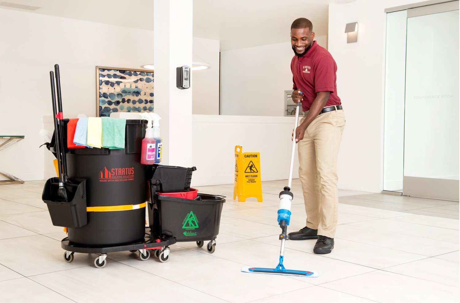 Stratus Franchisee Cleaning the Floor with a Mop and Mop Bucket