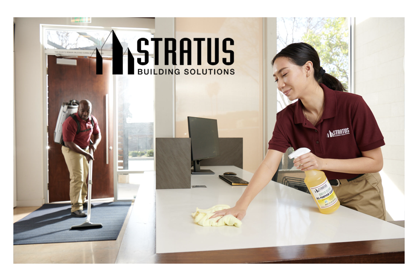 Side-by-Side Images of a Stratus Employee Vacuuming a Floor Mat and a Stratus Employee with a Spray Bottle Wiping a Desk 