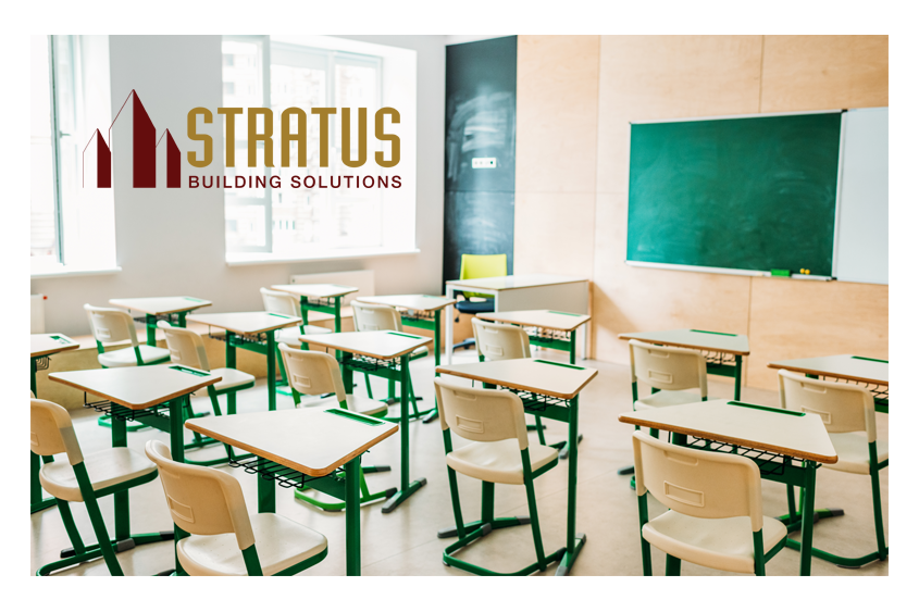 School classroom with desks and a chalkboard with the Stratus Logo