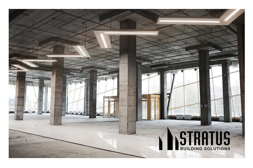 Large Office Interior Under Construction with Open Beams and Concrete Floors in Need of Cleaning